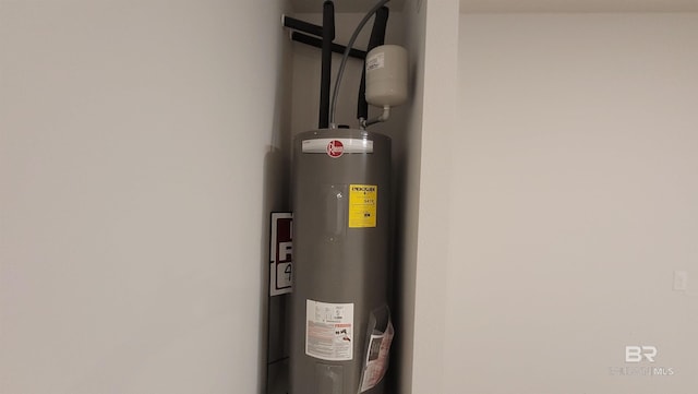 utility room featuring electric water heater