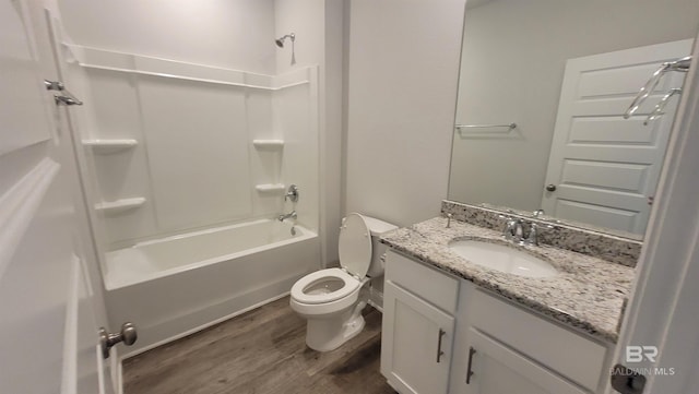 full bathroom featuring hardwood / wood-style flooring, vanity, toilet, and  shower combination