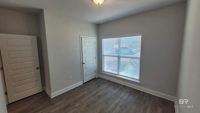 spare room with dark hardwood / wood-style floors