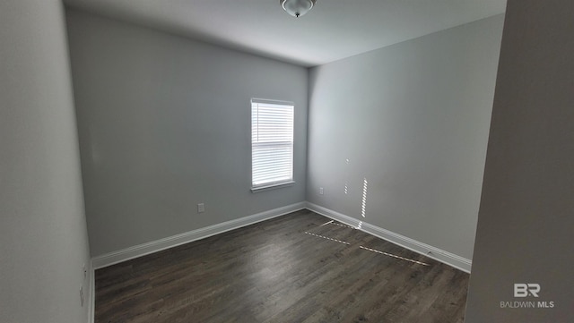 unfurnished room featuring dark hardwood / wood-style flooring