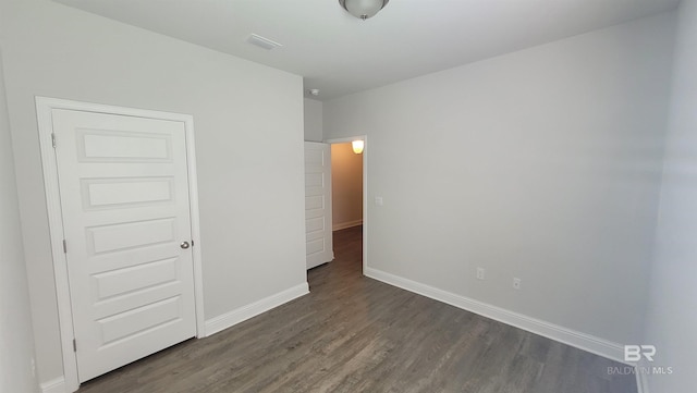 unfurnished bedroom with dark hardwood / wood-style floors