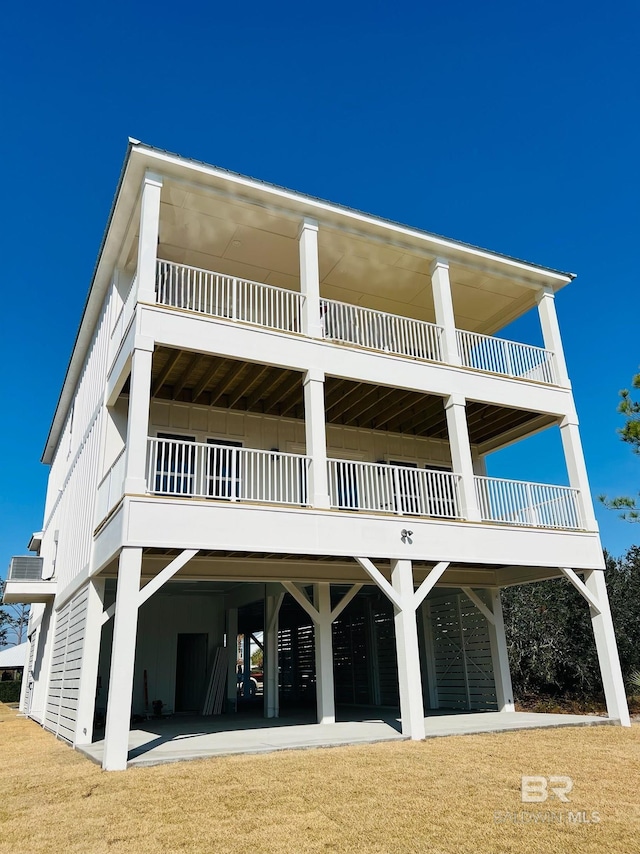 rear view of house with a carport and board and batten siding