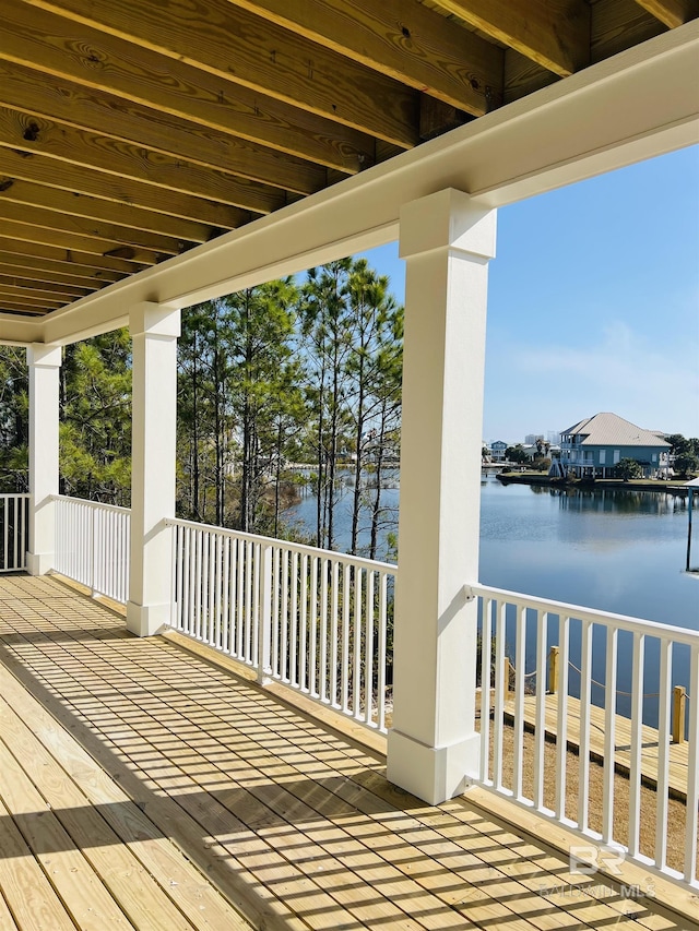 wooden terrace featuring a water view