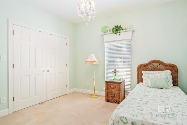 bedroom featuring carpet, a closet, and a chandelier