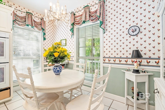 tiled dining space with an inviting chandelier