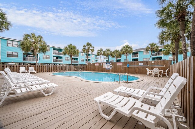 728 W Beach Blvd Unit 121, Gulf Shores, AL 36542 - community pool featuring a wooden deck, fence, and a residential view