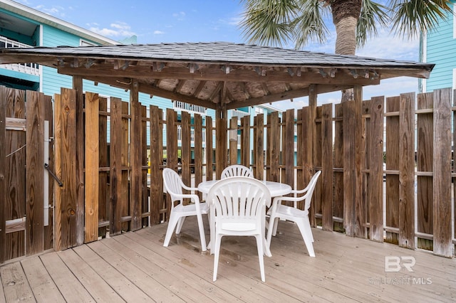 728 W Beach Blvd Unit 121, Gulf Shores, AL 36542 - wooden deck featuring a gazebo and outdoor dining space