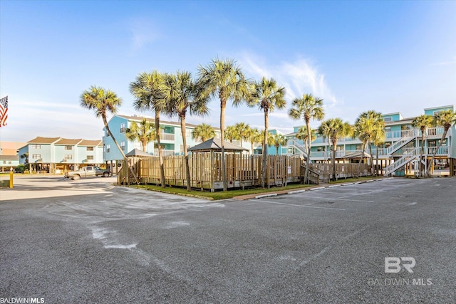 728 W Beach Blvd Unit 121, Gulf Shores, AL 36542 - view of front of house featuring uncovered parking, a residential view, and fence