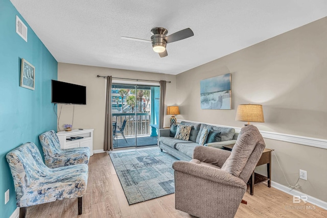728 W Beach Blvd Unit 121, Gulf Shores, AL 36542 - living room with ceiling fan, a textured ceiling, light wood-type flooring, and visible vents