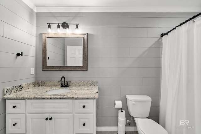 bathroom with vanity, ornamental molding, and toilet