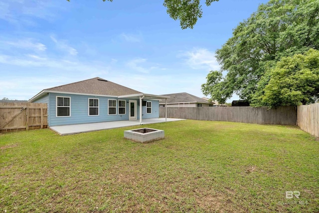 rear view of house featuring a patio, a fenced backyard, and a yard