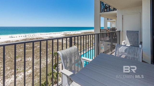 balcony with a view of the beach and a water view