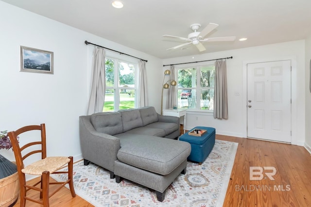 living room with hardwood / wood-style flooring and ceiling fan