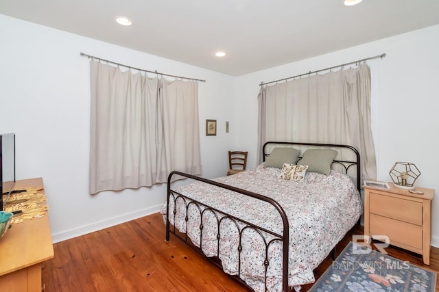 bedroom with hardwood / wood-style flooring