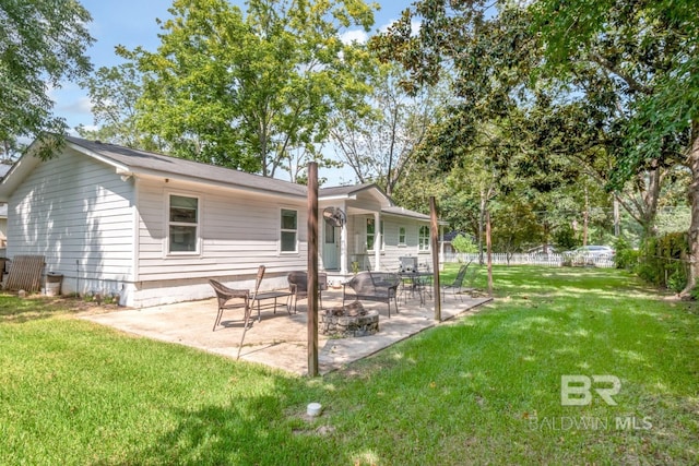 rear view of house featuring a patio and a lawn