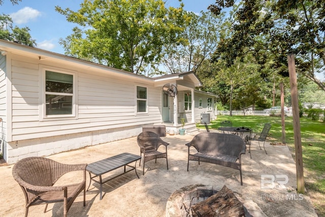 view of patio featuring central AC unit and an outdoor fire pit