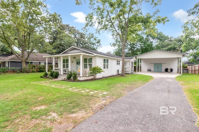 ranch-style home with a front yard, a carport, and covered porch