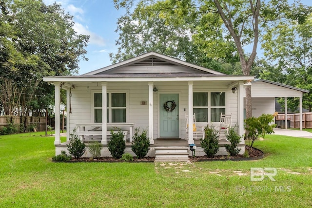 bungalow-style home with covered porch and a front lawn