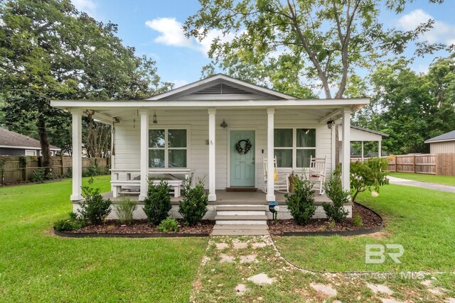 view of front of property with a front yard and covered porch