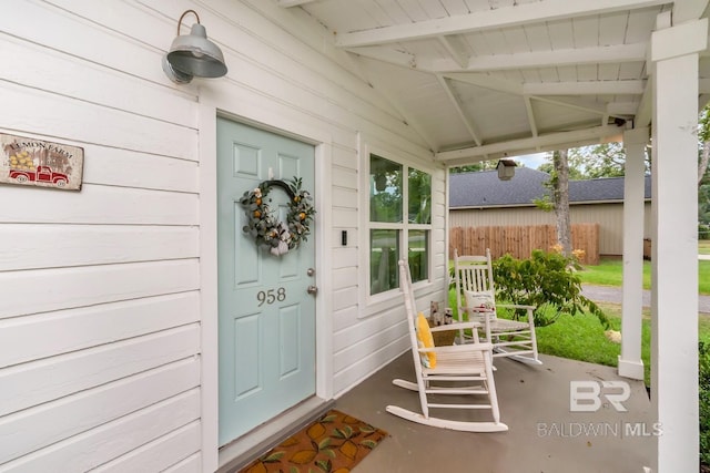 view of exterior entry with covered porch