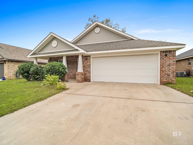 view of front facade featuring a front lawn, a garage, and central AC unit