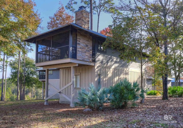 rear view of property with a sunroom