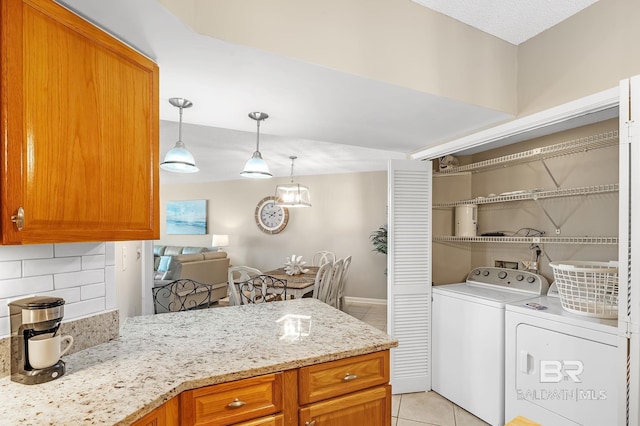 25020 Perdido Beach Blvd Unit 804B, Orange Beach, AL 36561 - laundry area with light tile patterned floors and independent washer and dryer