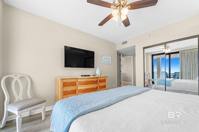 25020 Perdido Beach Blvd Unit 804B, Orange Beach, AL 36561 - bedroom featuring lofted ceiling, ceiling fan, light hardwood / wood-style floors, a textured ceiling, and access to outside