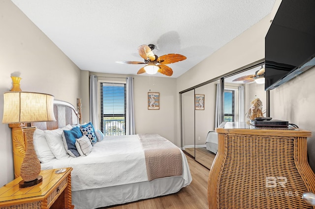 25020 Perdido Beach Blvd Unit 804B, Orange Beach, AL 36561 - bedroom featuring ceiling fan, light hardwood / wood-style floors, a closet, and a textured ceiling