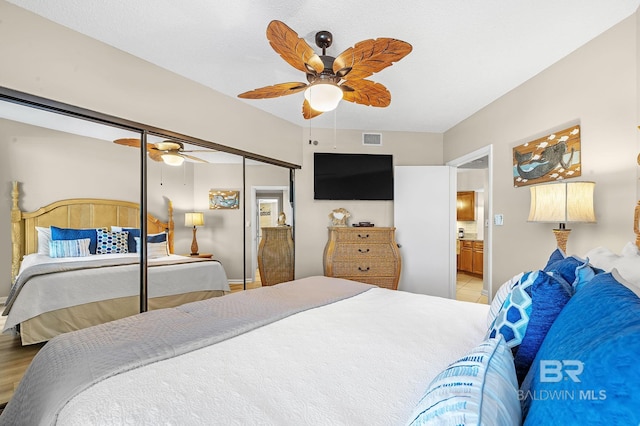 25020 Perdido Beach Blvd Unit 804B, Orange Beach, AL 36561 - bedroom with ceiling fan and ensuite bath