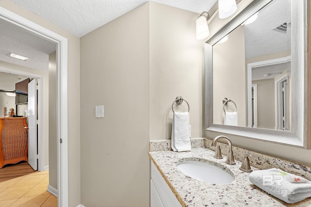 25020 Perdido Beach Blvd Unit 804B, Orange Beach, AL 36561 - bathroom with vanity, tile patterned floors, and a textured ceiling