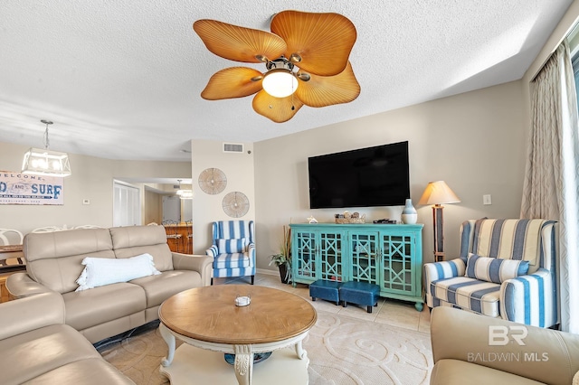 25020 Perdido Beach Blvd Unit 804B, Orange Beach, AL 36561 - tiled living room with ceiling fan and a textured ceiling
