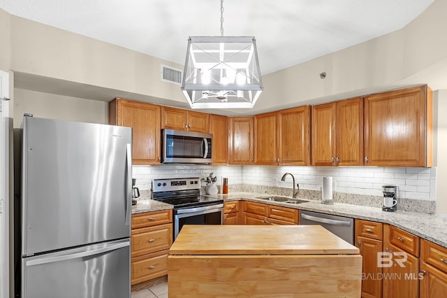 25020 Perdido Beach Blvd Unit 804B, Orange Beach, AL 36561 - kitchen featuring sink, tasteful backsplash, decorative light fixtures, a center island, and stainless steel appliances