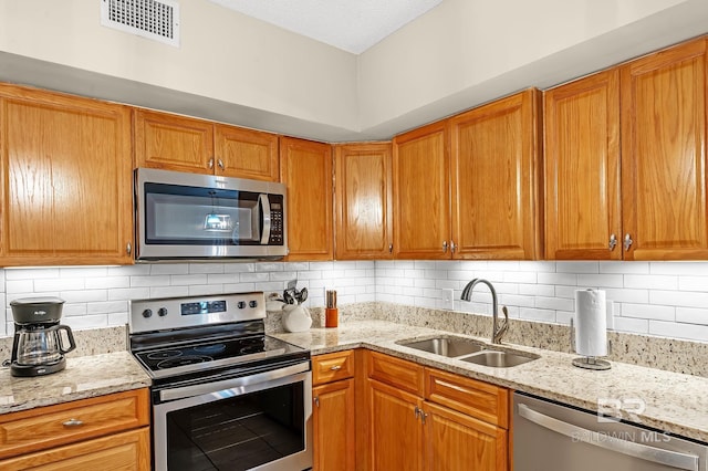 25020 Perdido Beach Blvd Unit 804B, Orange Beach, AL 36561 - kitchen featuring tasteful backsplash, sink, light stone countertops, and appliances with stainless steel finishes