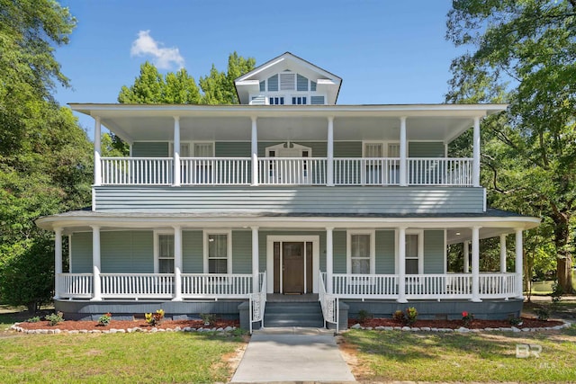 farmhouse inspired home with a balcony and a porch