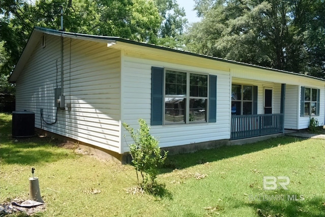 view of home's exterior featuring central AC and a yard