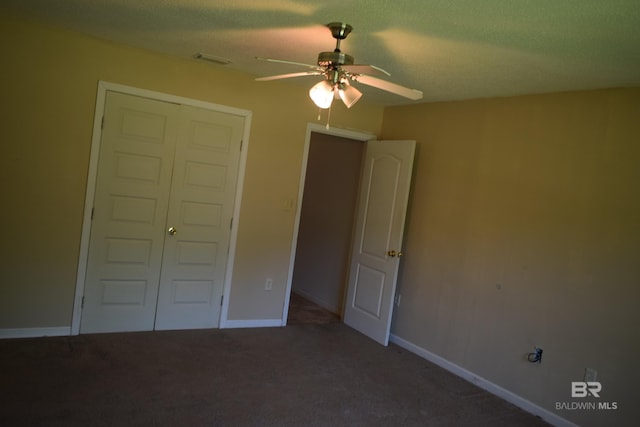 unfurnished bedroom with carpet flooring, a closet, ceiling fan, and a textured ceiling