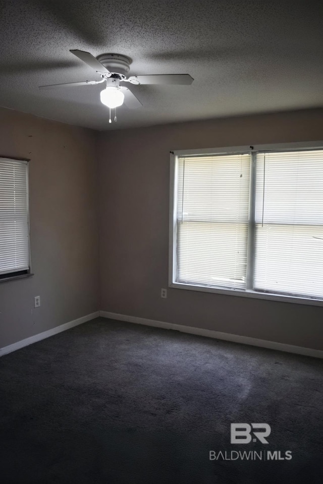 empty room featuring a textured ceiling, carpet flooring, and ceiling fan