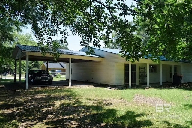 rear view of property featuring a lawn