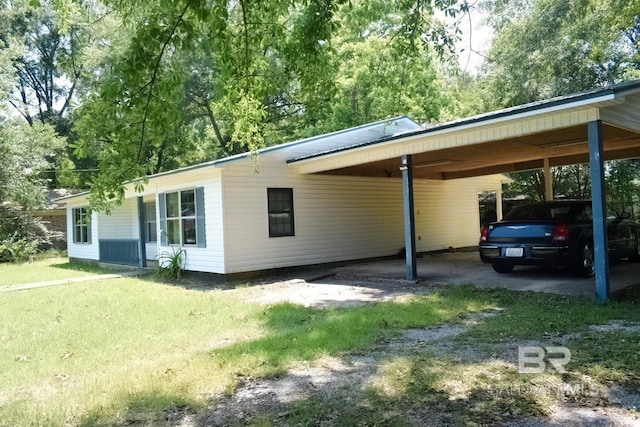 view of vehicle parking with a carport and a yard