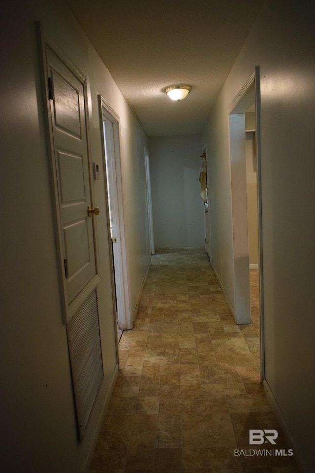 hallway featuring light tile floors