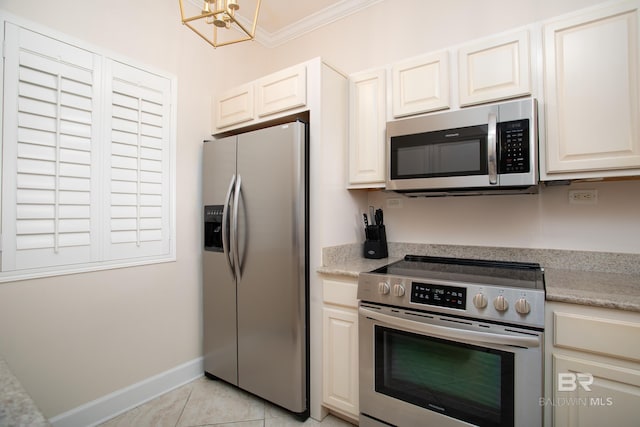 kitchen featuring light tile patterned floors, a notable chandelier, crown molding, white cabinets, and appliances with stainless steel finishes