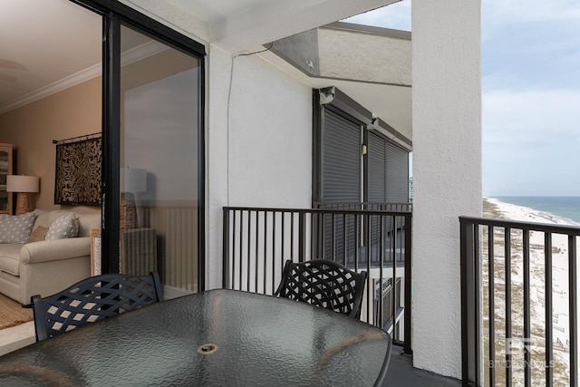 balcony with a water view and a beach view