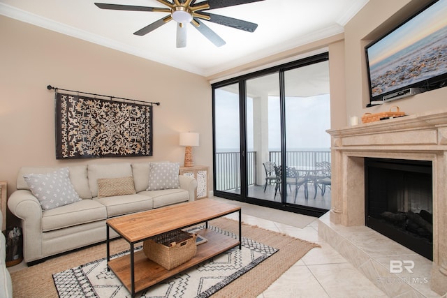 living room with expansive windows, ceiling fan, crown molding, and light tile patterned floors