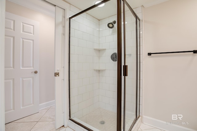 bathroom featuring tile patterned floors and a shower with shower door