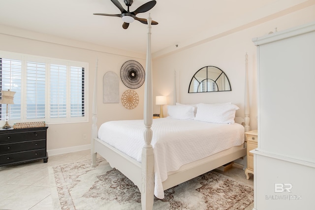 tiled bedroom featuring ceiling fan