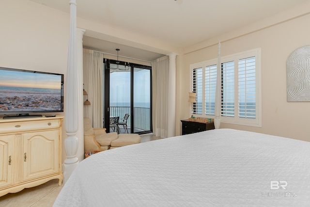 tiled bedroom featuring access to exterior and decorative columns