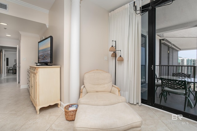 living area featuring light tile patterned floors and ornamental molding