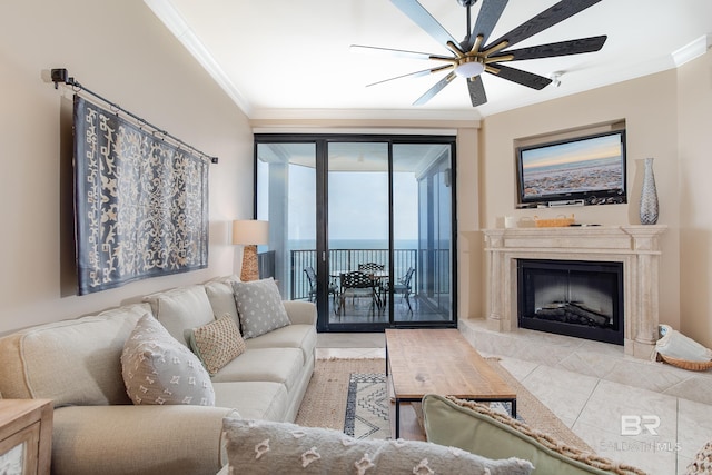 tiled living room featuring a tile fireplace, ceiling fan, and ornamental molding