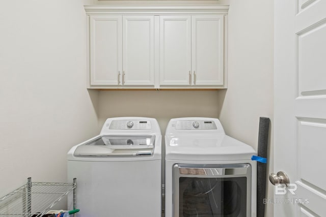 laundry room with cabinets and washer and clothes dryer